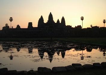 Angkor Wat shortly after sunrise, reflecting in pond out front