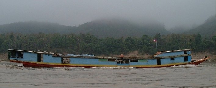 Passing by a long boat, on the Mekong