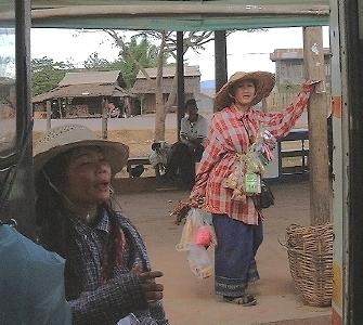 Two Lao women, selling snacks and drinks to riders on a long-range bus [also at Salavan]