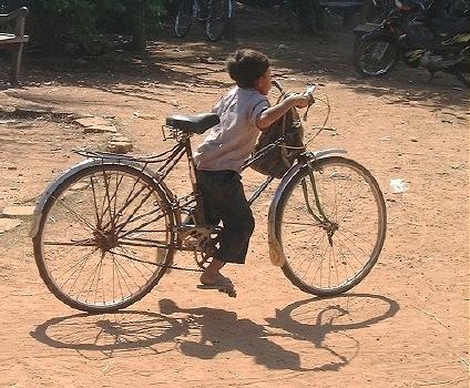 Small boy on a big bike!  (Angkor, Laos)